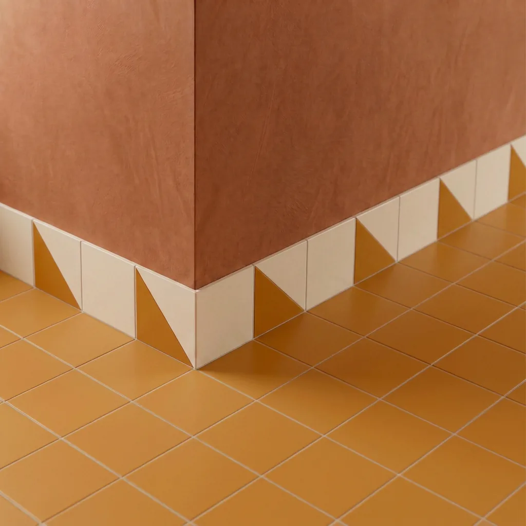 Azulejo Trigone Crema 10x10 Naranja Mango Mate colocado como cenefa en un suelo